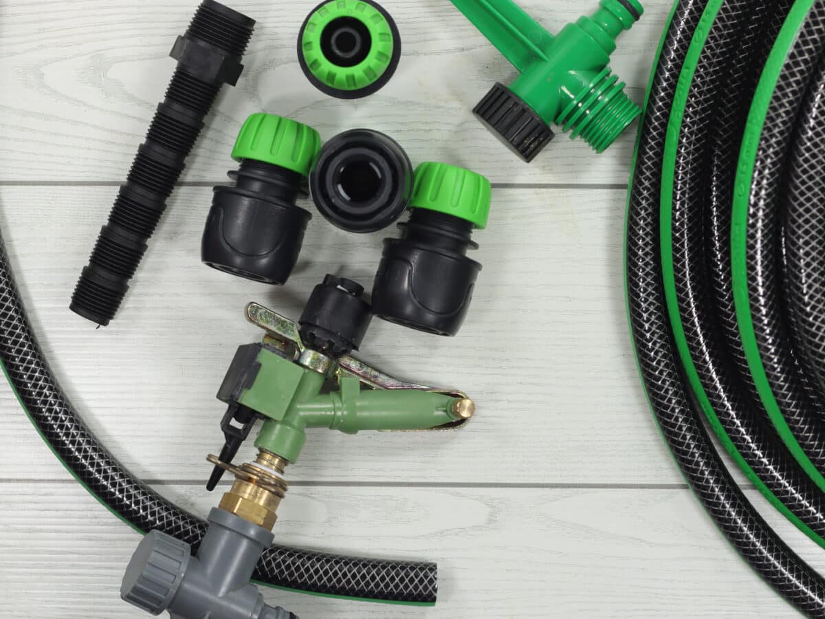 Drip irrigation parts including tubing and fittings laid out for a home system