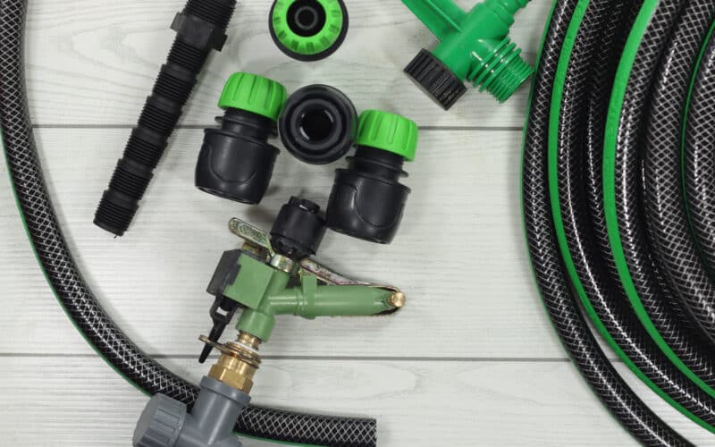 Drip irrigation parts including tubing and fittings laid out for a home system