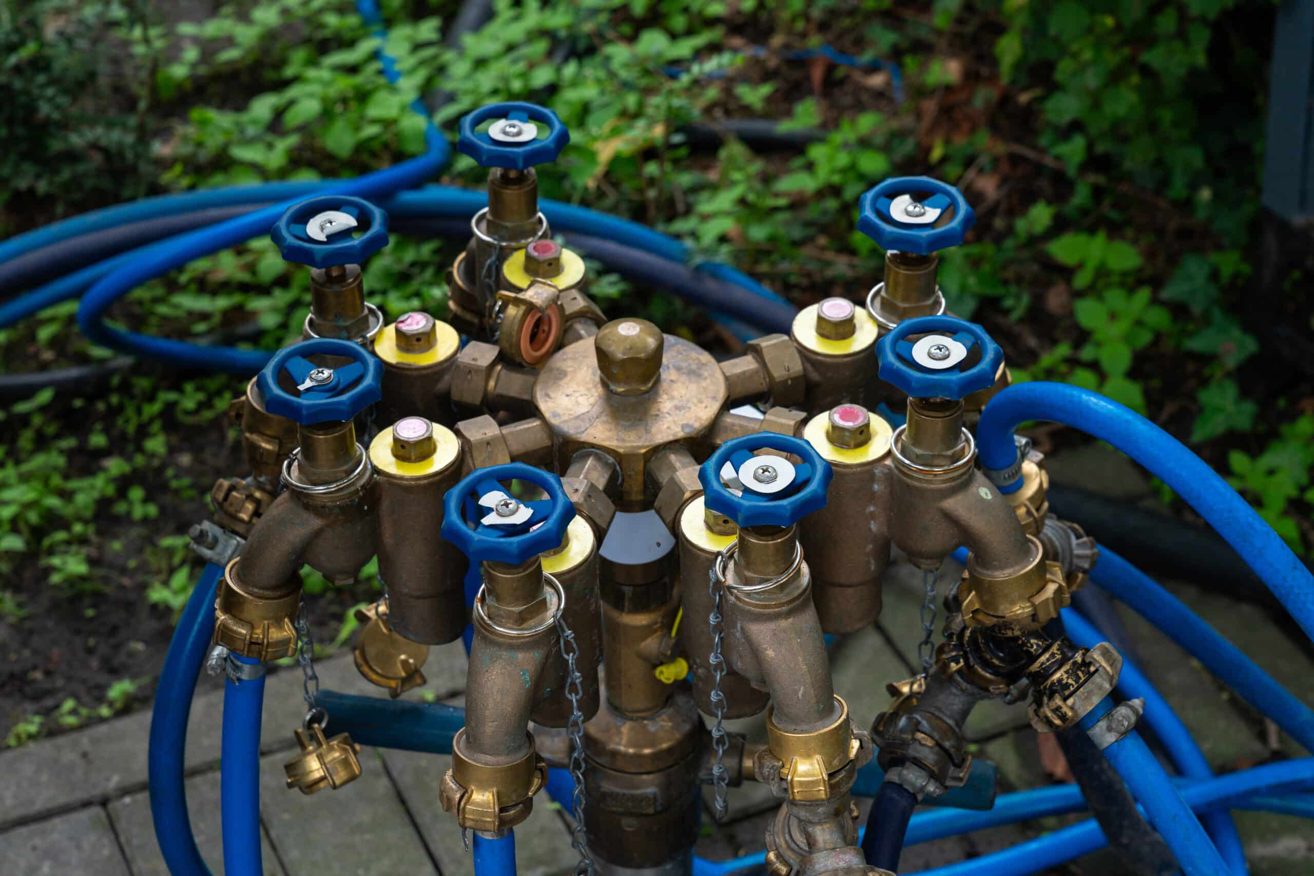 Spigot assembly with timer, backflow preventer, filter, and pressure regulator connected in line