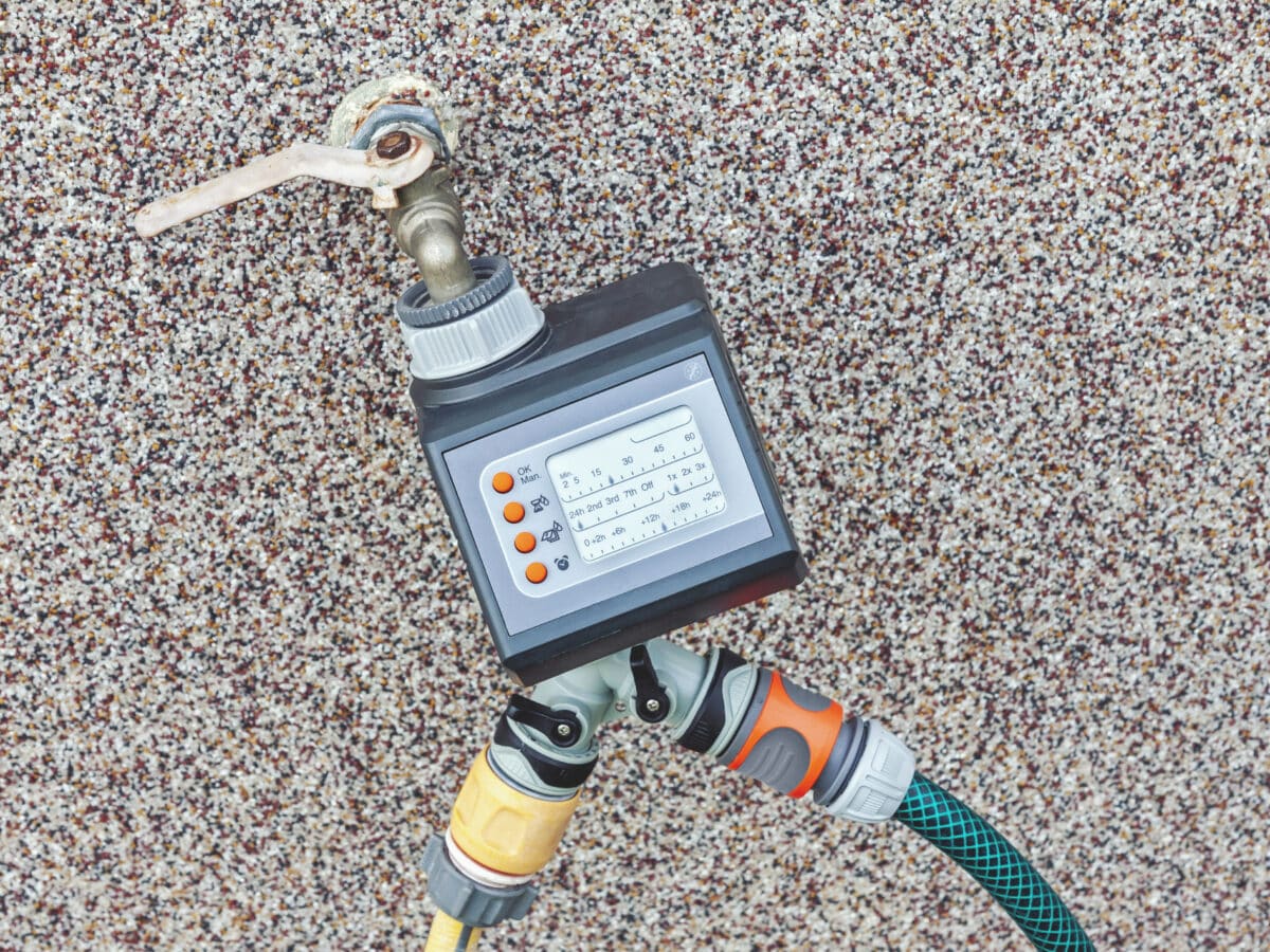 Battery-powered hose timer mounted on an outdoor spigot