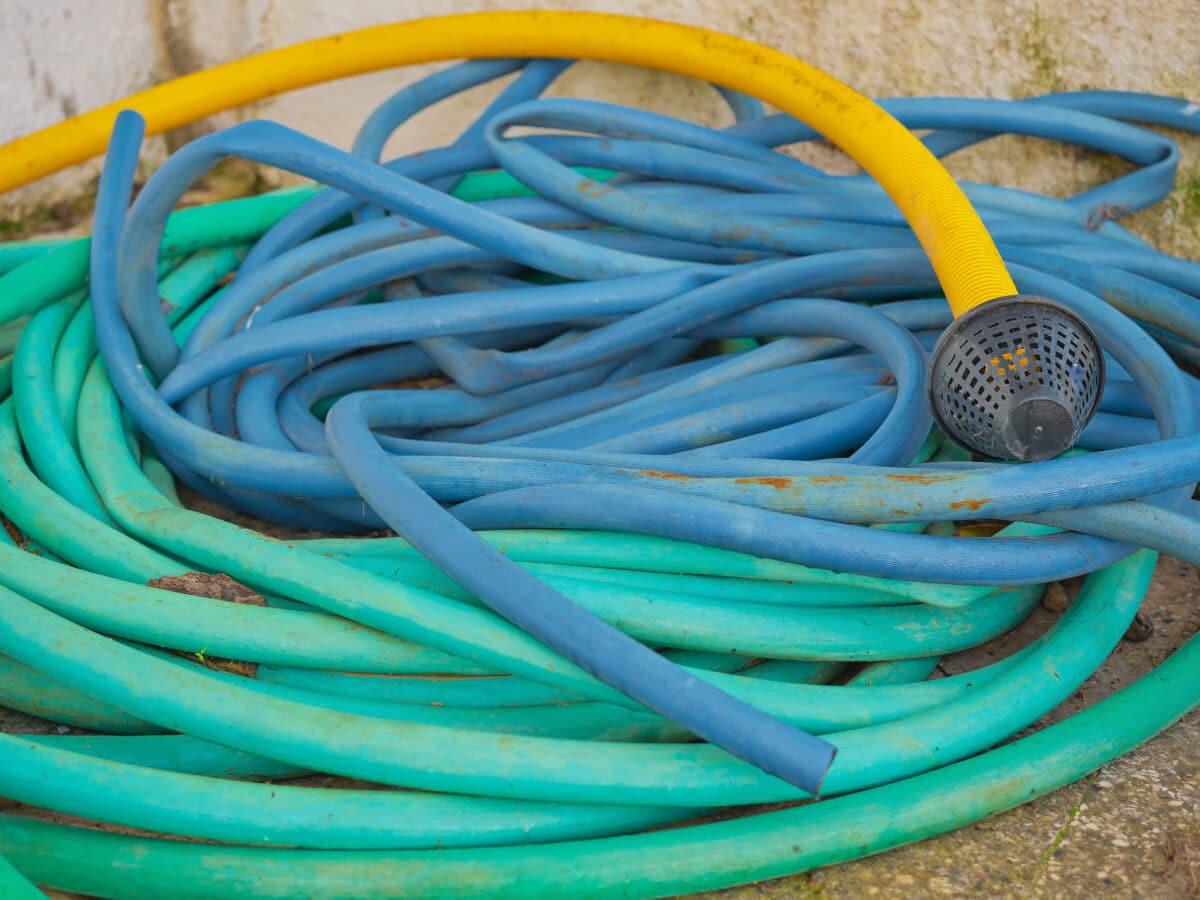 Coils of garden irrigation tubing in different diameters side by side