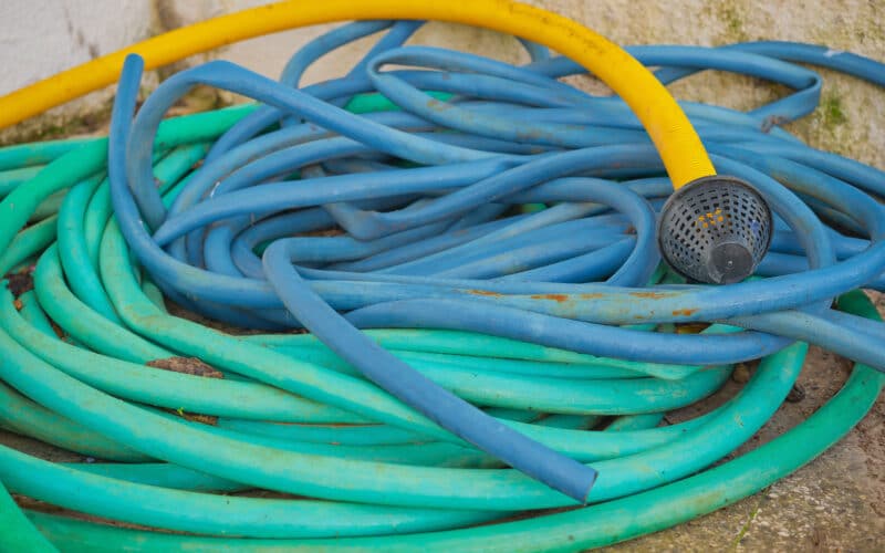 Coils of garden irrigation tubing in different diameters side by side