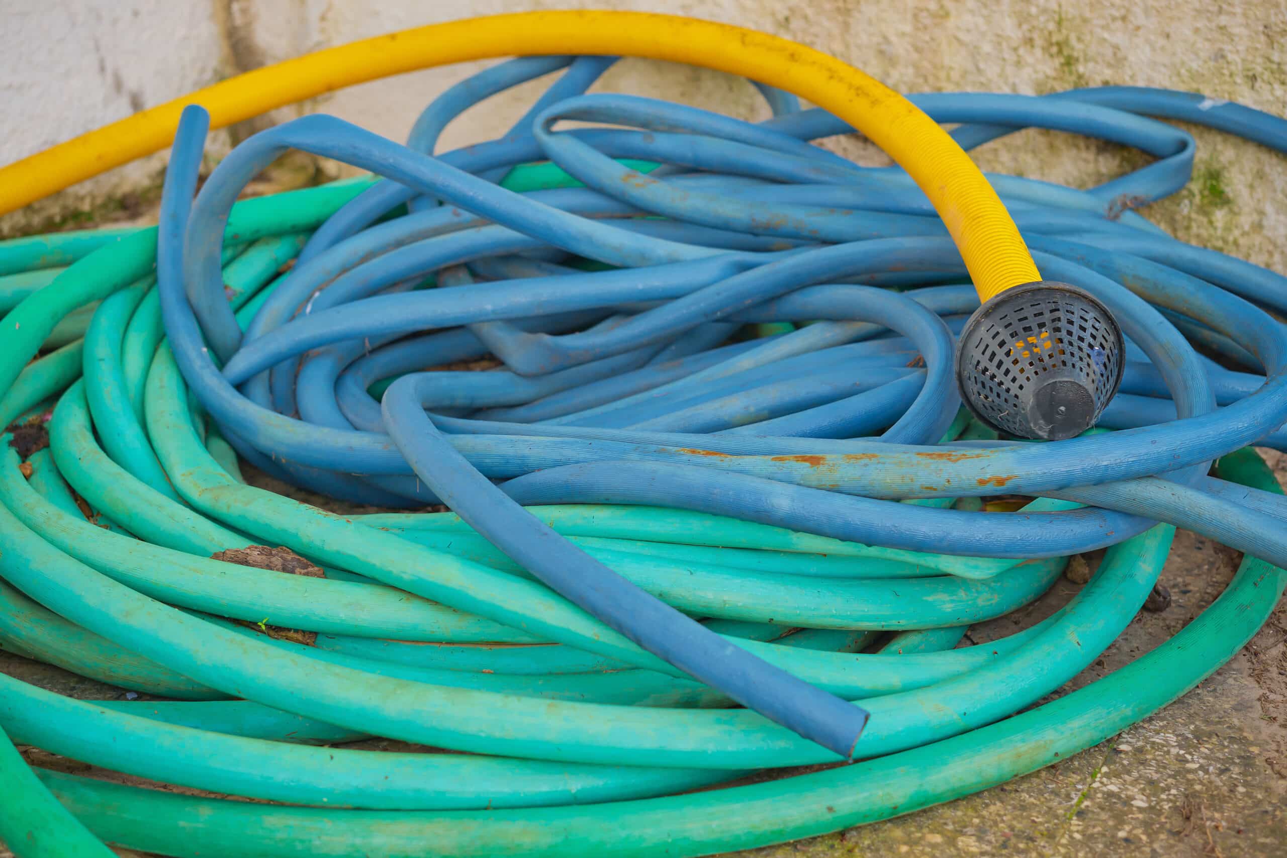 Coils of garden irrigation tubing in different diameters side by side