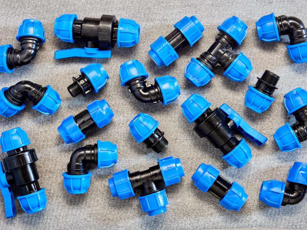 Assortment of drip and soaker hose fittings and connectors laid out