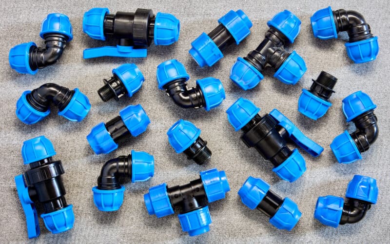 Assortment of drip and soaker hose fittings and connectors laid out