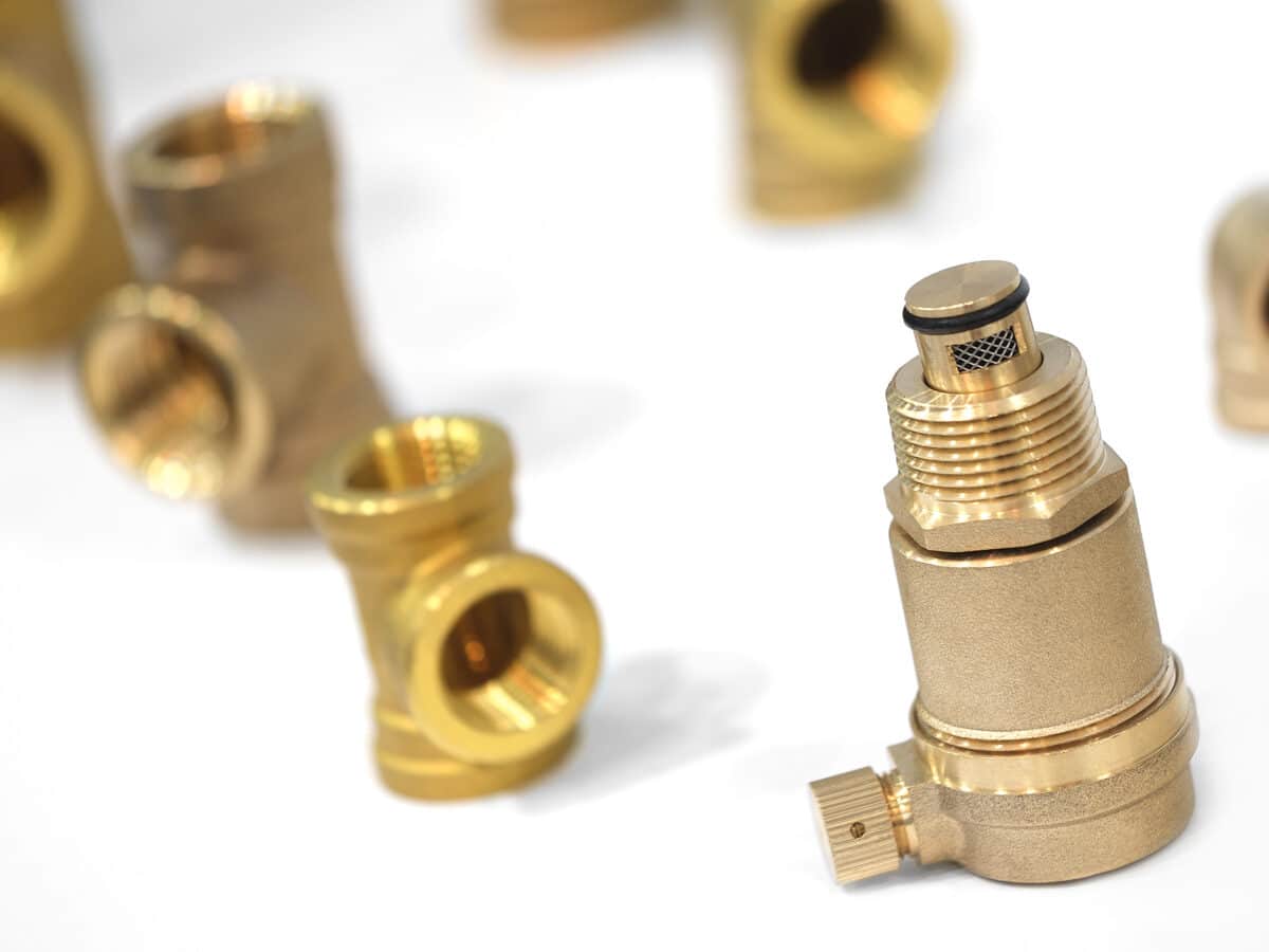 Inline pressure regulator screwed onto a garden spigot assembly for drip irrigation